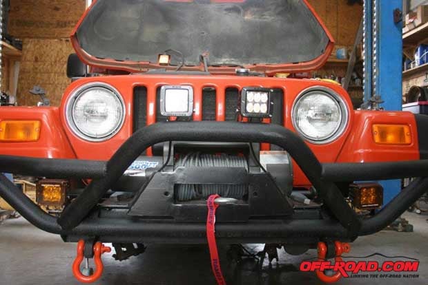 Front bumper, winch, and lights are mounted and finished. As noted, the lower fog lights are wired into the OEM fog light switch, while the higher driving lights will be wired through a relay to the Jeeps high beams.