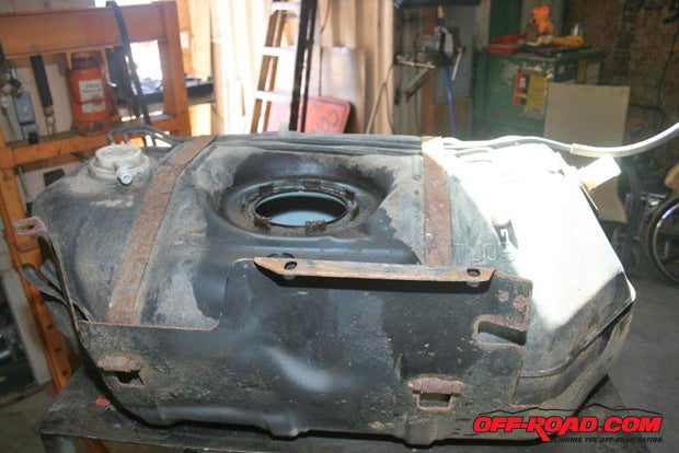 This is the original Jeep tank. Its supposed to be 19 gallonsaccording to Jeeps factory LJ specificationsbut we believe this was a replacement tank because it was marked as a TJ tank, which holds 15 gallons. (Due to New Hampshires wild winters and super salting of its road surfaces, the original tank, its mounts and/or its skid plate rusting out could have caused a tank replacement.)