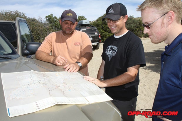 A big hood and large-flared fiberglass fenders make for a perfect map-reading surface. Dan, Matt, and Dave confer about where to go next.