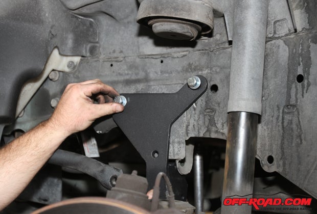 The new BDS track bar mounting plate gets installed, held in place by the two motor mount bolts on the drivers side and the lower track bar hole that was drilled out. BDS suggests torqueing the 10mm hardware to 30 lb.-ft., while the 12mm should be at 60 lb.-ft.