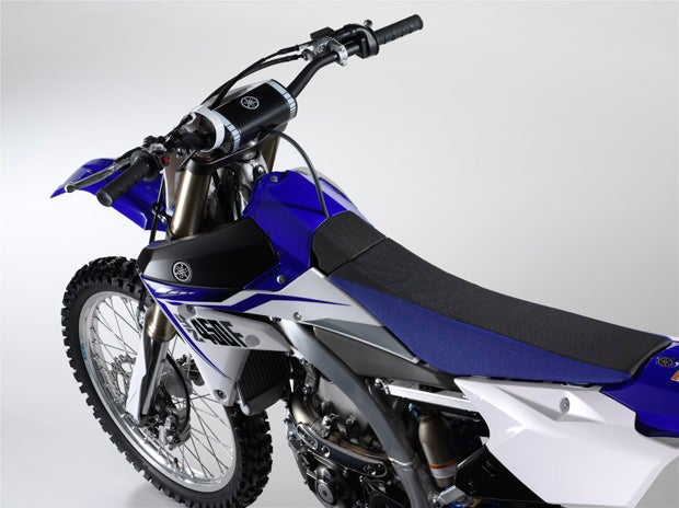 An updated seat design places the fuel fill below the two-piece seat on the 2014 YZs.